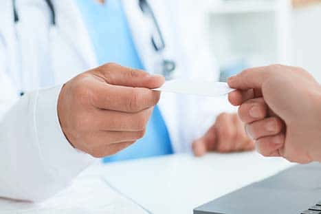 doctor handing a card